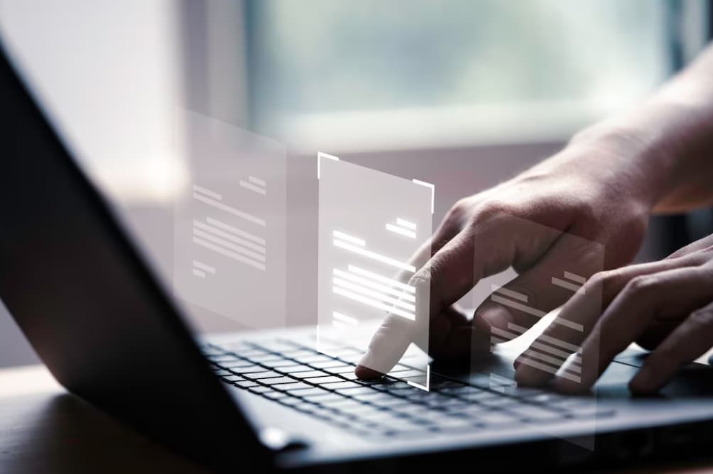 Close-up of hands typing on a laptop keyboard with digital data overlay